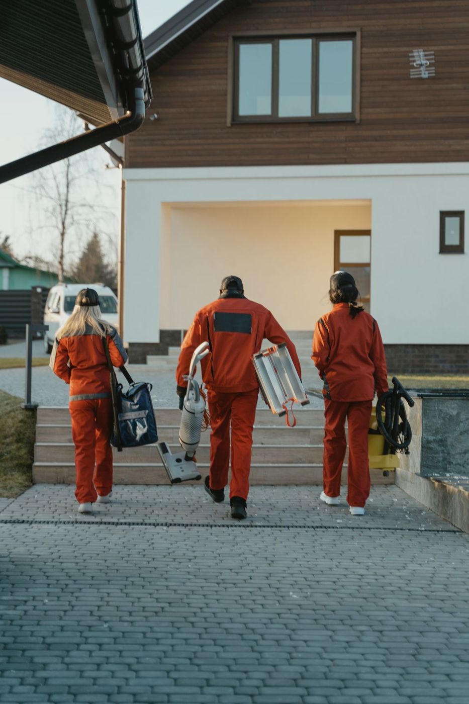 Cleaning team with equipment arriving at a property
